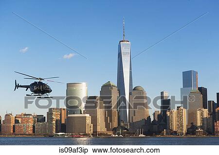 Helicopter flying over river, New York, USA View Large Photo Image Stock Photography - Helicopter flying over river, New York, USA. Fotosearch