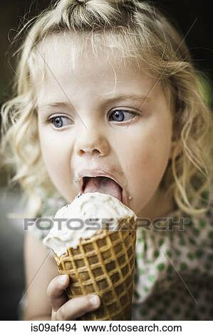 Little girl licking an ice cream View Large Photo Image Picture - Little girl licking an ice cream. Fotosearch