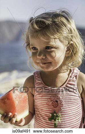Little girl with a watermelon slice View Large Photo Image Stock Image - Little girl with a watermelon slice. Fotosearch
