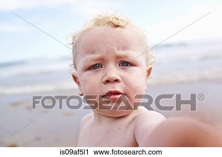 Stock Image - Male toddler on the beach. Fotosearch