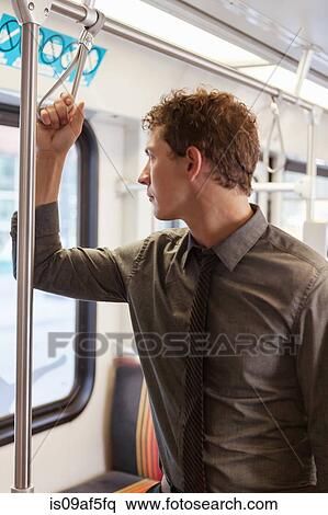 Mid adult businessman staring out of train carriage window View Large Photo Image Stock Photography - Mid adult businessman staring out of train carriage window. Fotosearch