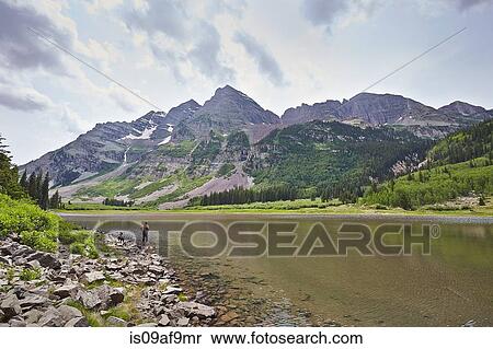 Stock Photography - Mid adult woman paddling in mountain river, Aspen, Colorado, USA. Fotosearch