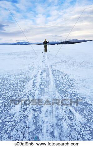 Mid adult woman skiing across vast landscape, Colter Bay, Wyoming, USA View Large Photo Image Stock Photograph - Mid adult woman skiing across vast landscape, Colter Bay, Wyoming, USA. Fotosearch