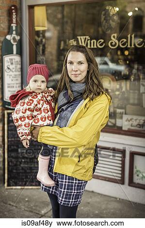 Stock Photo - Mother and baby in front of wine shop, Port Townsend, Washington, USA. Fotosearch