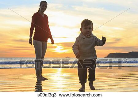 Stock Image - Mother and toddler son playing on beach, San Diego, California, USA. Fotosearch