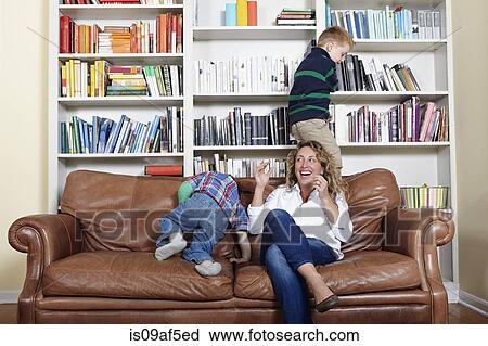 Mother and young sons playing on sofa View Large Photo Image Stock Image - Mother and young sons playing on sofa. Fotosearch