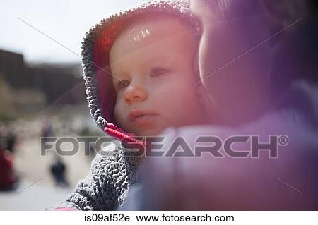 Mother holding daughter wearing hood View Large Photo Image Stock Image - Mother holding daughter wearing hood. Fotosearch