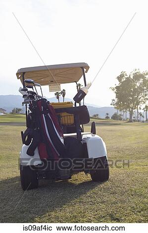 Parked golf buggy on green View Large Photo Image Stock Image - Parked golf buggy on green. Fotosearch
