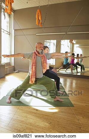 People doing warrior pose in yoga class View Large Photo Image Stock Image - People doing warrior pose in yoga class. Fotosearch