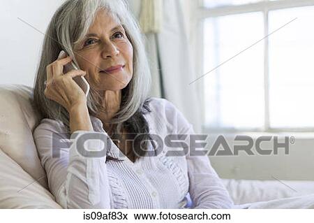 Portrait of attractive senior woman chatting on smartphone View Large Photo Image Stock Photo - Portrait of attractive senior woman chatting on smartphone. Fotosearch