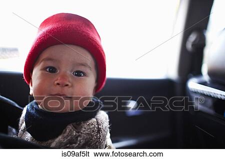 Stock Photograph - Portrait of baby boy in car. Fotosearch
