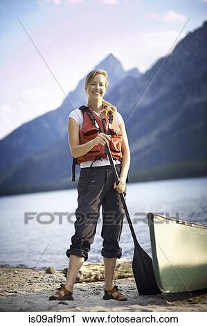 Portrait of female canoeist by lake, Grand Tetons, Wyoming, USA View Large Photo Image Stock Image - Portrait of female canoeist by lake, Grand Tetons, Wyoming, USA. Fotosearch