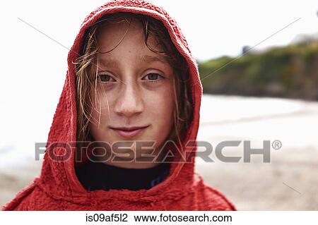 Stock Image - Portrait of girl in red hooded top. Fotosearch