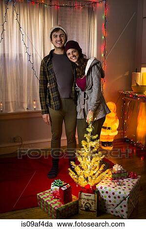 Stock Image - Portrait of happy young couple at christmas. Fotosearch