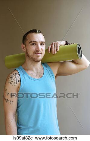 Portrait of man holding yoga mat View Large Photo Image Stock Image - Portrait of man holding yoga mat. Fotosearch