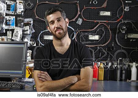 Portrait of mid adult man in motorcycle shop View Large Photo Image Stock Image - Portrait of mid adult man in motorcycle shop. Fotosearch