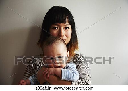 Picture - Portrait of mother holding baby boy. Fotosearch