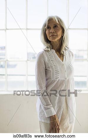 Stock Photograph - Portrait of senior woman in apartment. Fotosearch