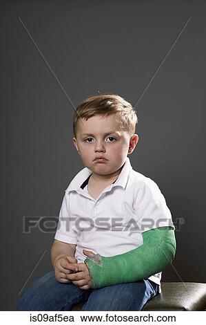 Portrait of sullen young boy with plaster cast on arm View Large Photo Image Stock Image - Portrait of sullen young boy with plaster cast on arm. Fotosearch