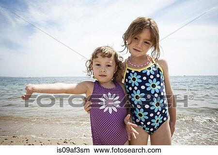 Picture - Portrait of two young sisters on beach at Falmouth, Massachusetts, USA. Fotosearch