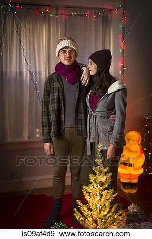 Stock Photo - Portrait of young couple at christmas. Fotosearch