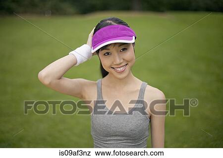 Stock Photo - Portrait of young female runner in park. Fotosearch