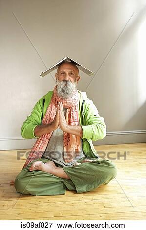 Senior man in lotus position with laptop on head View Large Photo Image Stock Photo - Senior man in lotus position with laptop on head. Fotosearch