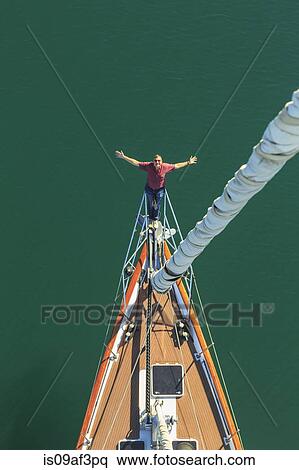 Stock Photography - Senior man seen sailing from above with arms outstretched, San Diego, California, USA. Fotosearch