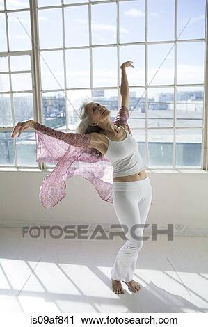 Senior woman dancing in sunlit apartment View Large Photo Image Stock Image - Senior woman dancing in sunlit apartment. Fotosearch