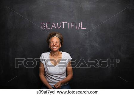 Senior woman in front of blackboard and the word beautiful View Large Photo Image Stock Image - Senior woman in front of blackboard and the word beautiful. Fotosearch