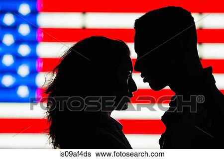 Silhouette of young couple in front of American flag View Large Photo Image Stock Photograph - Silhouette of young couple in front of American flag. Fotosearch