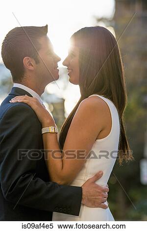 Stock Photography - Smart young couple hugging on city street, Toronto, Ontario, Canada. Fotosearch