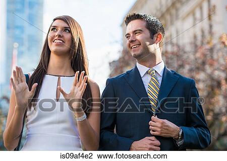 Stock Image - Smart young couple on city street, Toronto, Ontario, Canada. Fotosearch