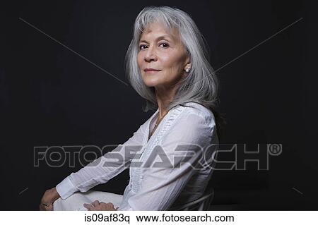 Stock Photography - Studio portrait of aloof senior woman. Fotosearch
