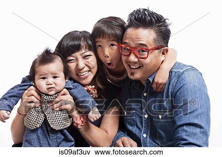 Stock Photo - Studio portrait of mid adult couple with daughter and baby boy. Fotosearch