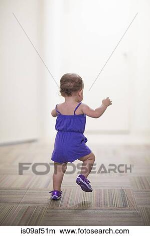 Picture - Toddler girl learning to walk. Fotosearch