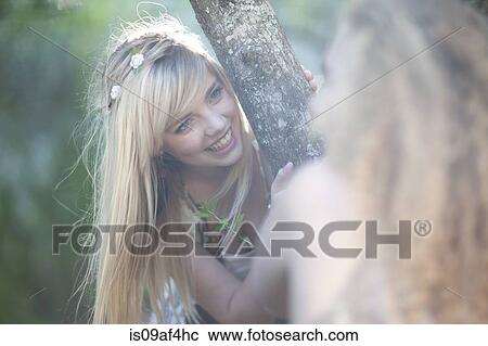Stock Image - Two teenage girls exploring woodland. Fotosearch