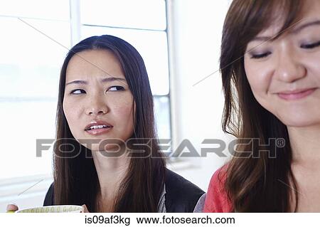 Two young women in kitchen in disagreement View Large Photo Image Stock Image - Two young women in kitchen in disagreement. Fotosearch