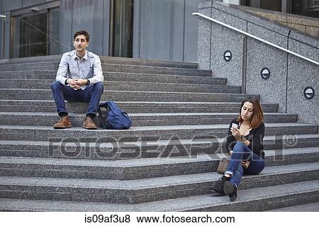 Unhappy couple sitting apart on steps View Large Photo Image Stock Photo - Unhappy couple sitting apart on steps. Fotosearch