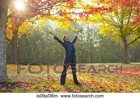 Picture - Woman stretching in forest. Fotosearch
