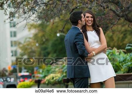Young couple hugging on city street, Toronto, Ontario, Canada View Large Photo Image Stock Photograph - Young couple hugging on city street, Toronto, Ontario, Canada. Fotosearch