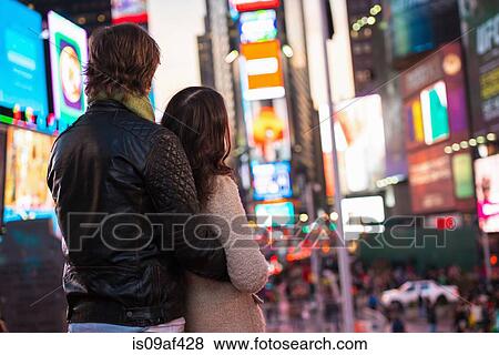 Young couple looking up at neon signs, New York City, USA View Large Photo Image Stock Photo - Young couple looking up at neon signs, New York City, USA. Fotosearch