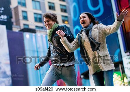 Young couple running on street, New York City, USA View Large Photo Image Stock Image - Young couple running on street, New York City, USA. Fotosearch
