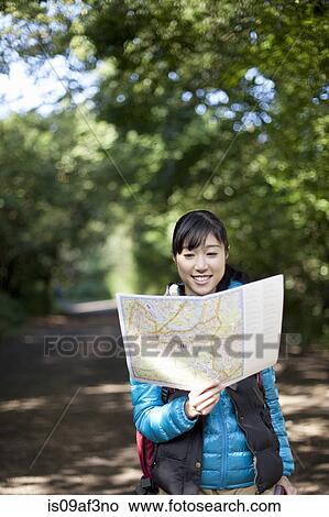 Young female hiker looking at map View Large Photo Image Picture - Young female hiker looking at map. Fotosearch