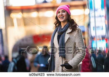 Stock Image - Young female tourist exploring streets, New York City, USA. Fotosearch