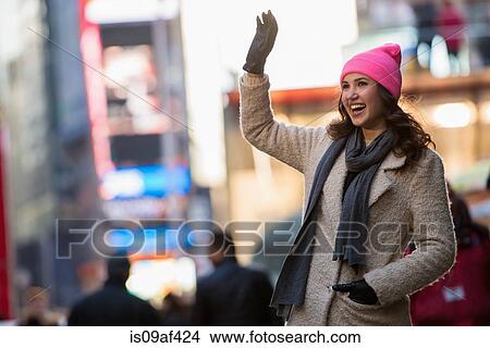 Young female tourist waving from street, New York City, USA View Large Photo Image Picture - Young female tourist waving from street, New York City, USA. Fotosearch