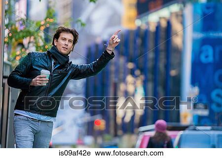 Young male tourist hailing a cab, New York City, USA View Large Photo Image Stock Image - Young male tourist hailing a cab, New York City, USA. Fotosearch