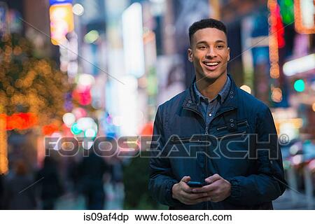 Stock Photography - Young male tourist on busy street, New York City, USA. Fotosearch
