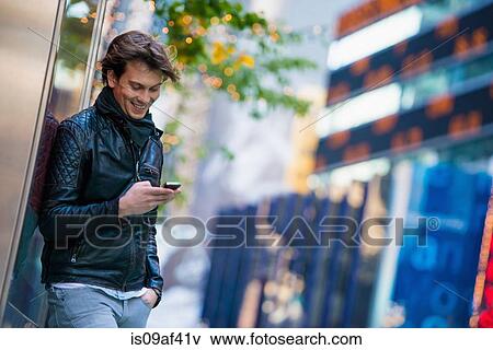 Young male tourist using smartphone, New York City, USA View Large Photo Image Stock Photo - Young male tourist using smartphone, New York City, USA. Fotosearch
