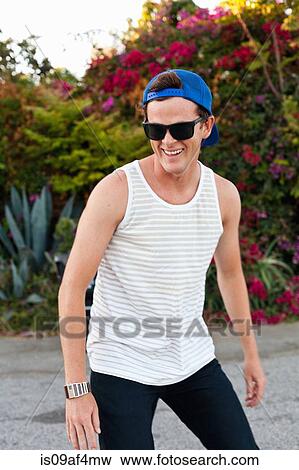 Young man skateboarding along sidewalk View Large Photo Image Stock Photo - Young man skateboarding along sidewalk. Fotosearch